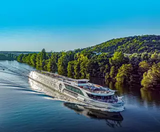 Image of the jane austen sailing down the calm waters of the river rhine against a blue sky